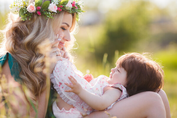 Happy woman with a child resting on the nature