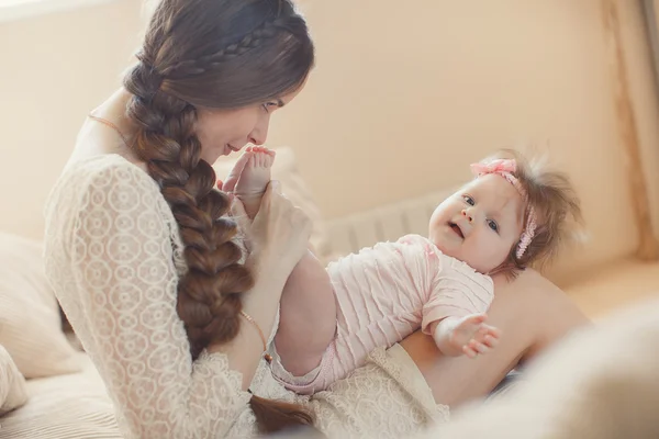 Happy mother playing with child at home — Stok fotoğraf