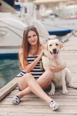 Bir köpeğin üstüne bir bağlama ile hamile bir kadın portresi.