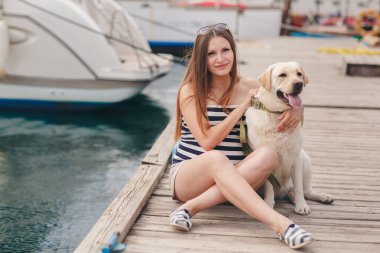 Bir köpeğin üstüne bir bağlama ile hamile bir kadın portresi.