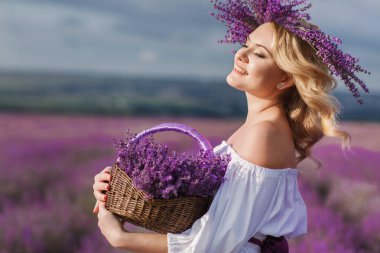 Beautiful woman in a field of blossoming lavender