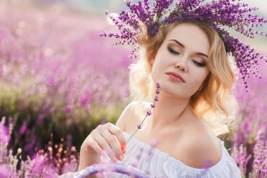 Beautiful woman in a field of blossoming lavender