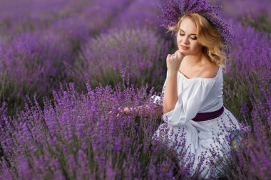 Beautiful woman in a field of blossoming lavender