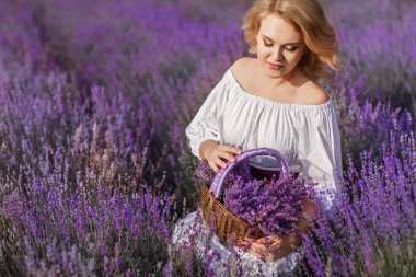 Beautiful woman in a field of blossoming lavender