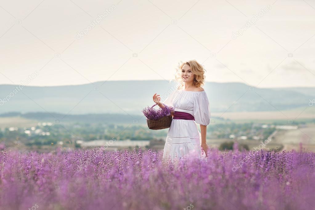 Beautiful woman in a field of blossoming lavender