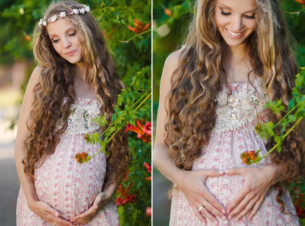 Schöne schwangere Frau in der Nähe des blühenden Busches im Park — Stockfoto