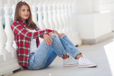 Açık havada gülümseyen genç kadın portresi.