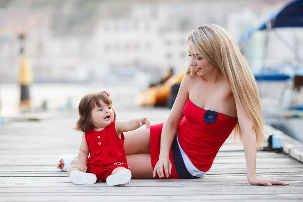 Joyeux jeune mère avec une jeune fille près du Yacht Club — Photo