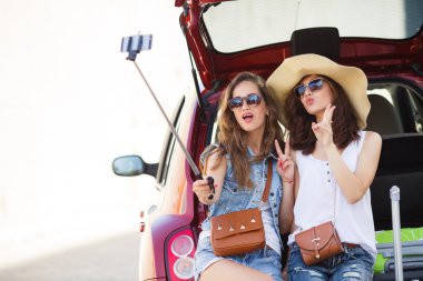 Selfie two girlfriends in the trunk of a car