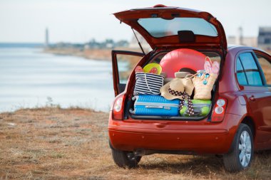 Suitcases and bags in trunk of car ready to depart for holidays clipart