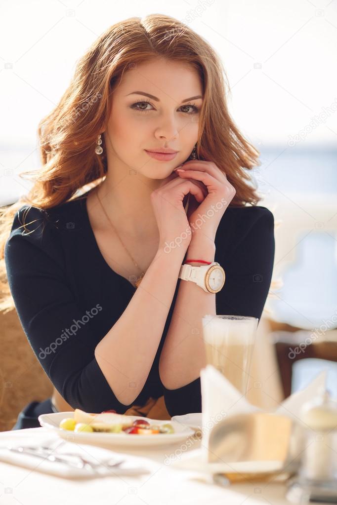Portrait of a happy woman outdoors in cafe