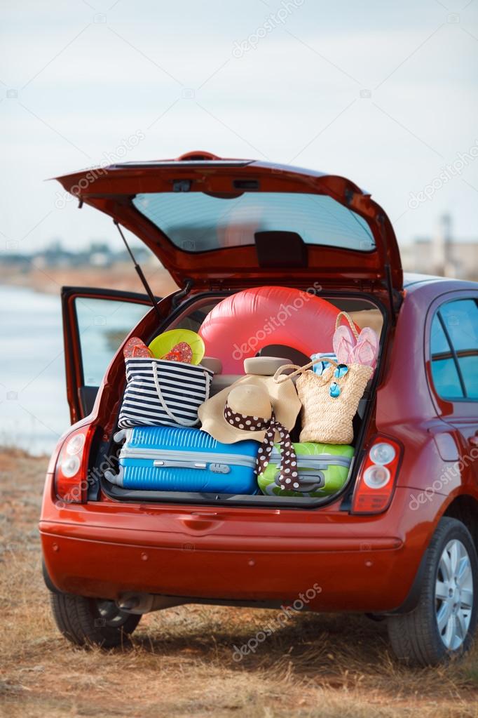 Suitcases and bags in trunk of car ready to depart for holidays