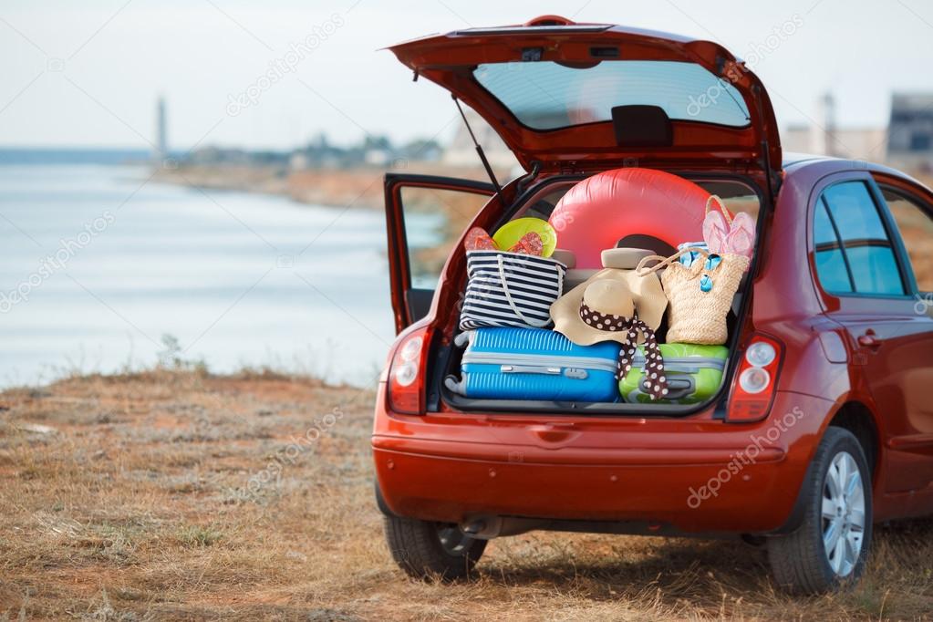 Suitcases and bags in trunk of car ready to depart for holidays