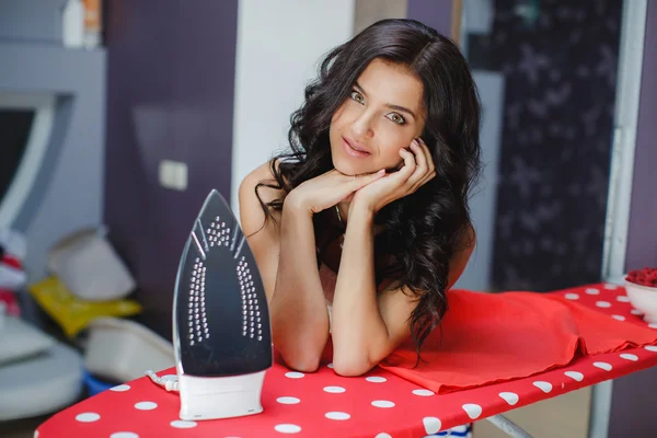 Happy young beautiful woman ironing clothes. — Stock Photo, Image