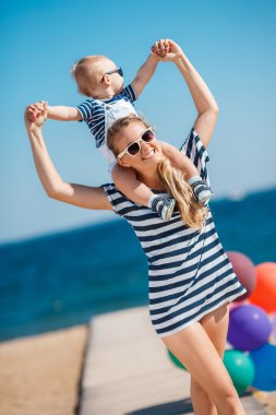 A young mother and her delightful little son on vacation at the beach