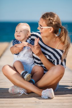 A young mother and her delightful little son on vacation at the beach