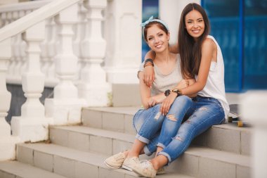 Portrait of beautiful young women in the summer city.