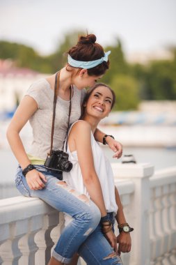 Portrait of beautiful young women in the summer city.