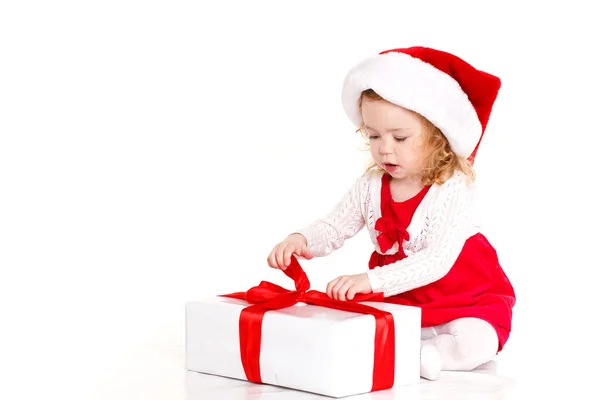 Child dressed as Santa with a Christmas present — Stok fotoğraf