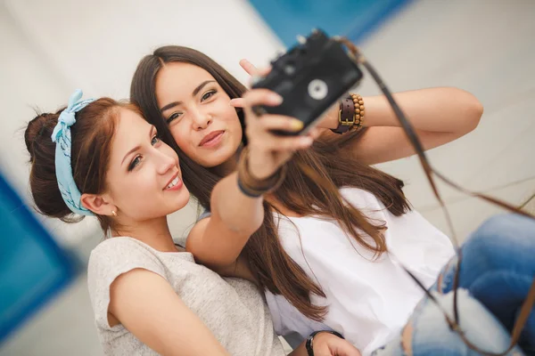 Happy girlfriends in the city with the camera — Stock Photo, Image