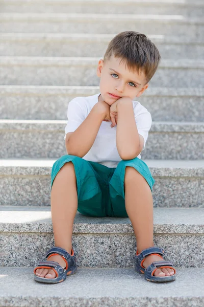 The boy sitting on the stairs in the underpass — Stock Fotó