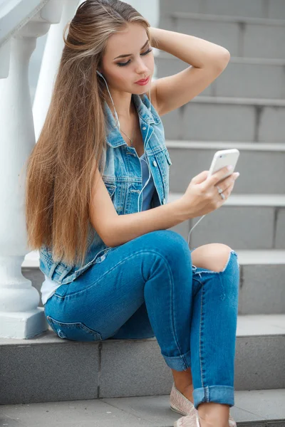 Girl listening to music,sitting on the steps — Stok fotoğraf