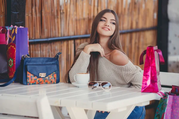 Charming woman in a cafe for a cup of coffee — Stok fotoğraf