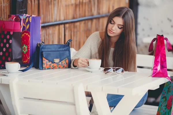 Charming woman in a cafe for a cup of coffee — Stok fotoğraf