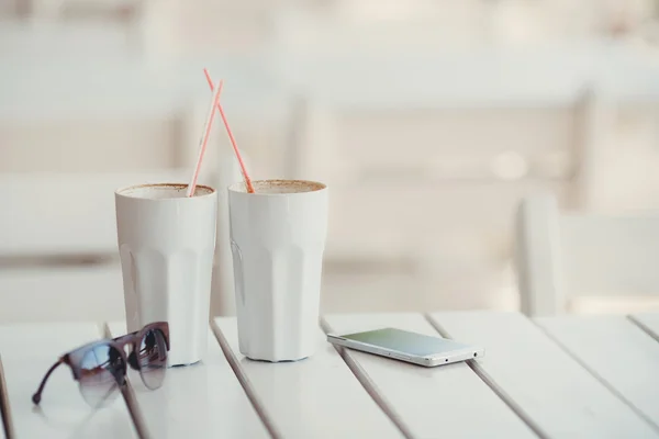 Morning coffee at a table in summer cafe — Stock Photo, Image