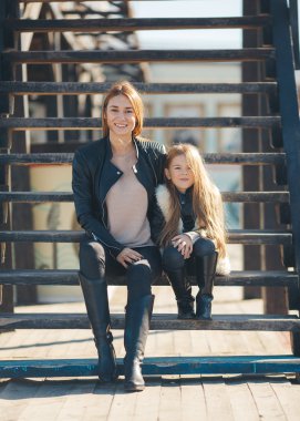 Autumn portrait of stylish mums and daughters