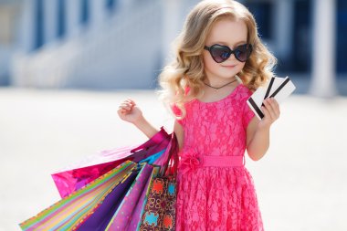 A young buyer with colored bags and credit card