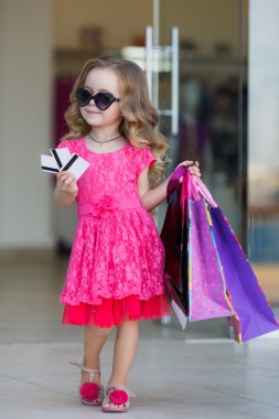 A young buyer with colored bags and credit card
