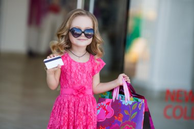 A young buyer with colored bags and credit card