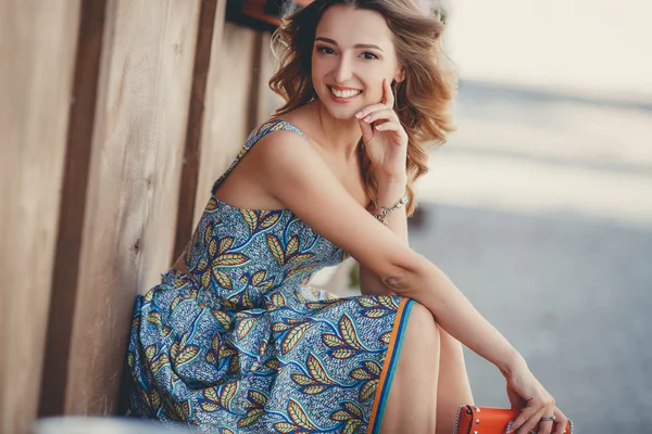 Portrait of a beautiful woman on a bench in the summer — Stock Fotó