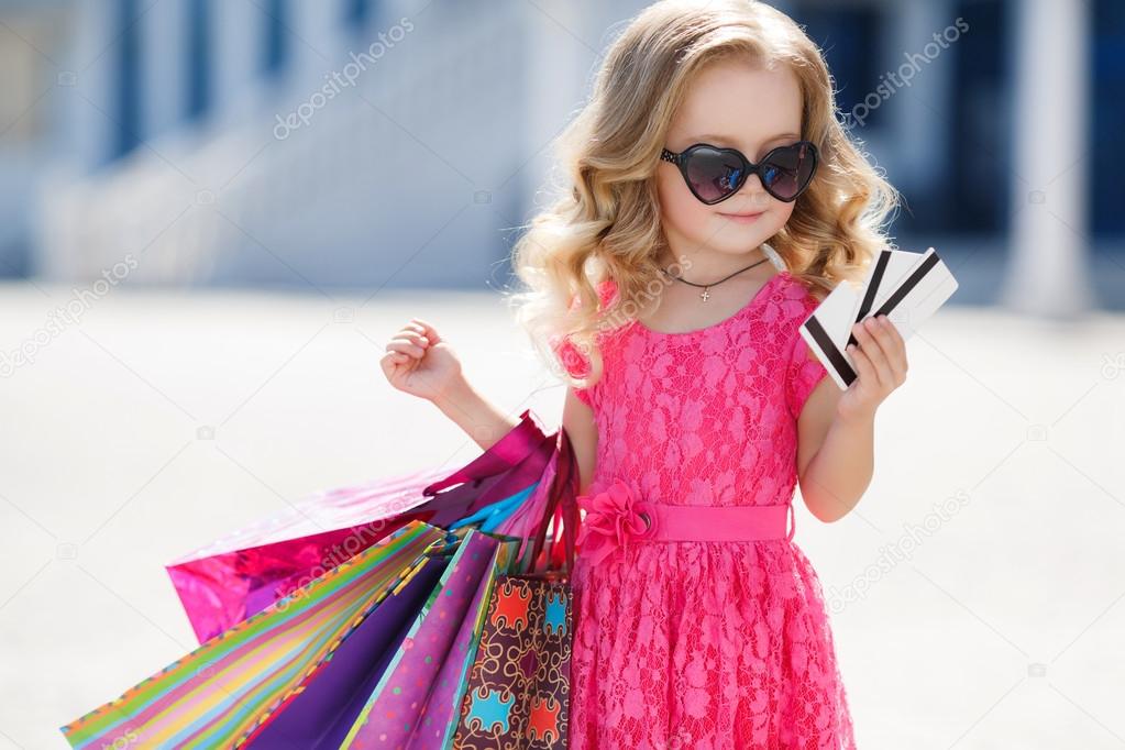 A young buyer with colored bags and credit card