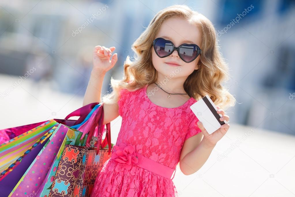 A young buyer with colored bags and credit card