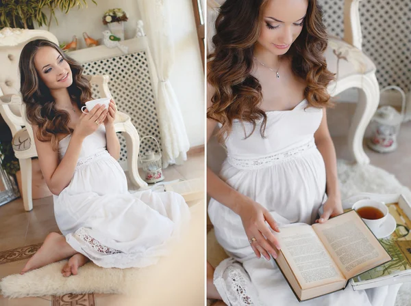Mujer embarazada leyendo un libro sentado en el suelo —  Fotos de Stock