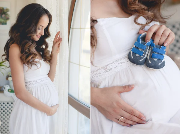 Pregnant woman belly holding baby booties. — Stock Photo, Image