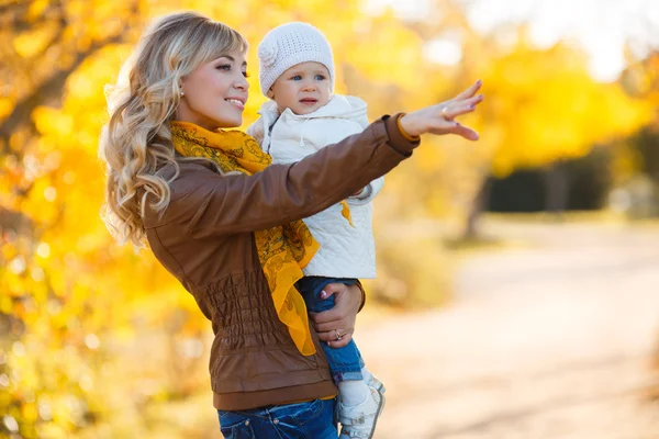 Mom and daughter resting in a park in autumn — Stock Photo, Image