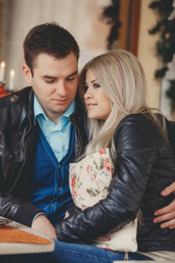 A young couple spends time in a city cafe