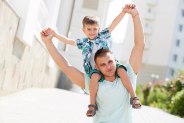 Father and son together on the street near the house