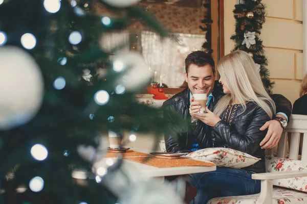 Beautiful young couple at a table in a cafe — Stock Photo, Image