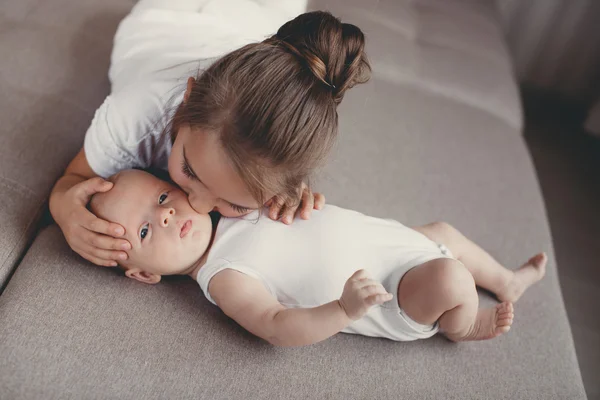 Little girl with a newborn baby brother — Stock Photo, Image