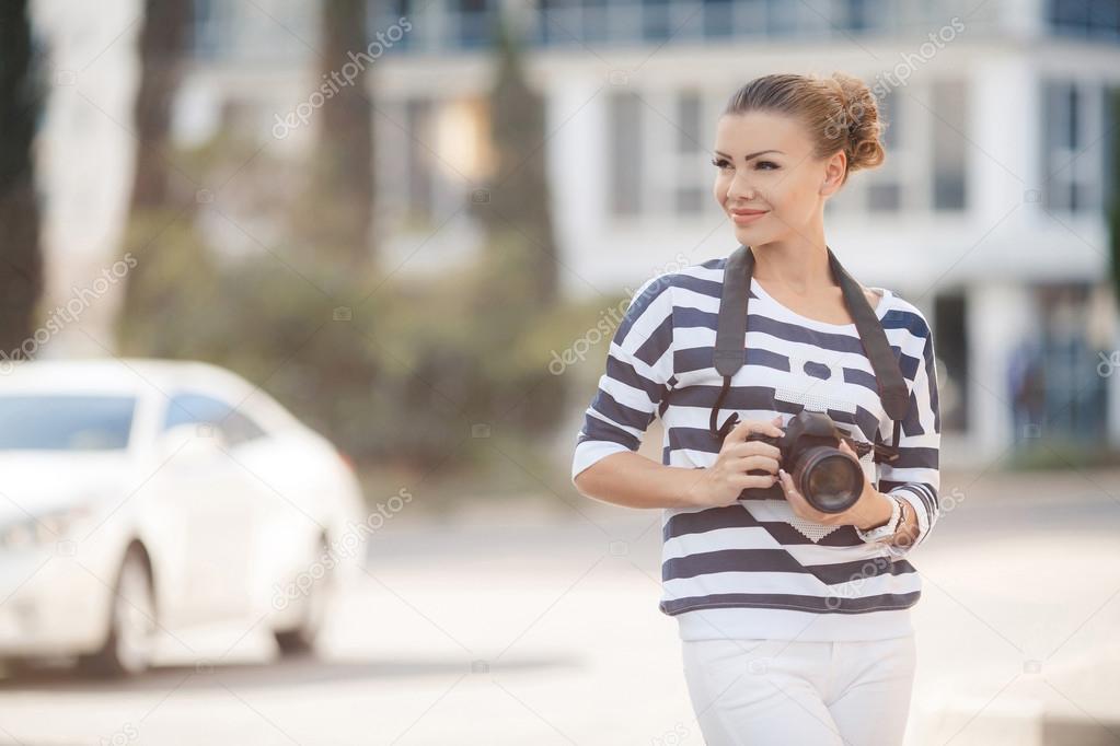 The beautiful female photographer with the digital camera