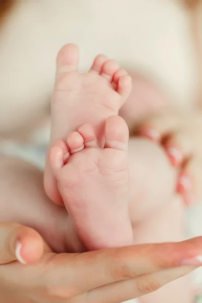 Children's legs on a mother's palm — Stock Photo, Image