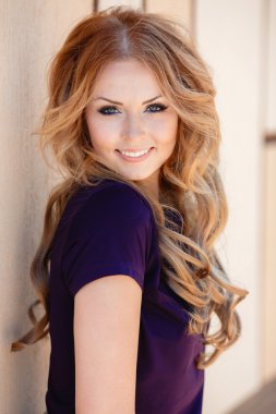 Summer portrait of beautiful red-haired woman.