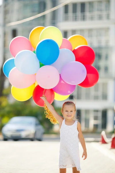 Portrait of little girl playing with air balloons — 图库照片