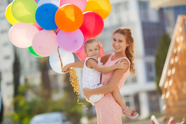 Moeder en kind met kleurrijke ballonnen — Stockfoto