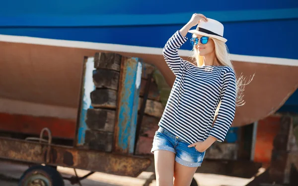 Beautiful woman in striped vest on the dock. — 图库照片