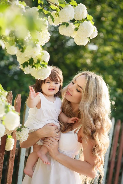 Portrait of happy woman with a small daughter in the village in the spring — Stok fotoğraf